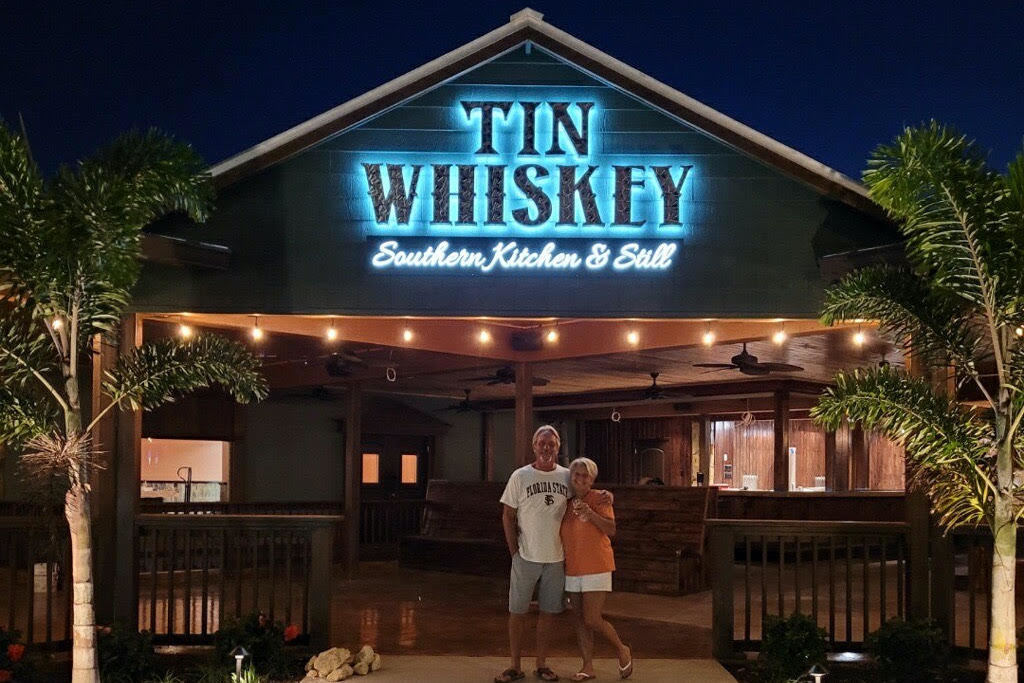 Tin whiskey front with owners