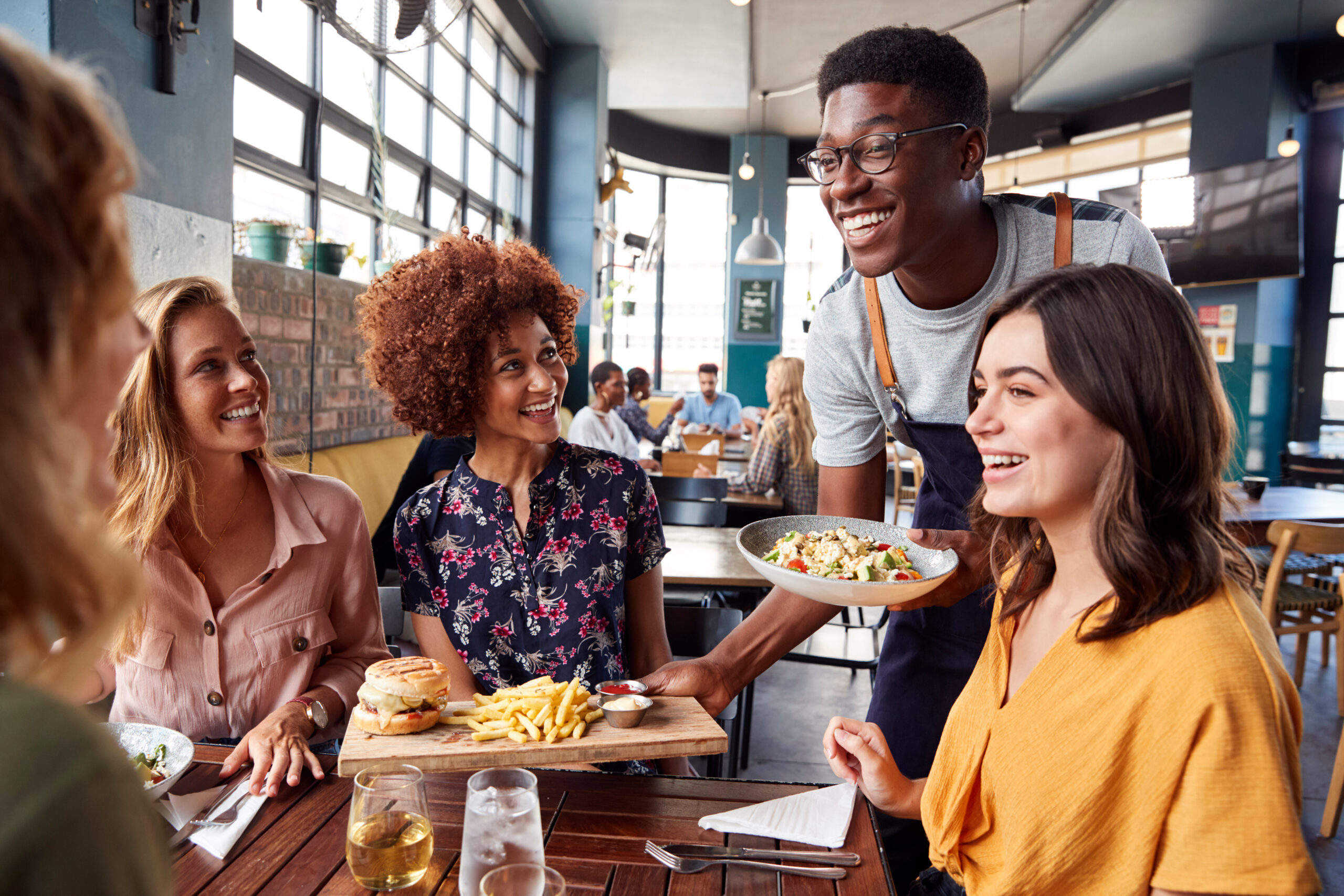 Waiter serving a group of customers